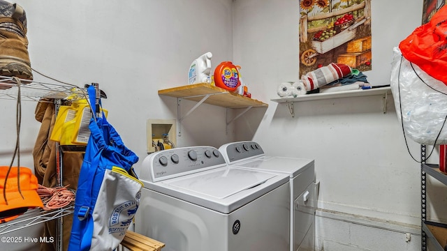 washroom featuring laundry area and washing machine and clothes dryer