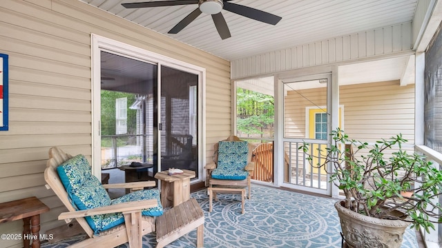 sunroom / solarium with plenty of natural light and a ceiling fan