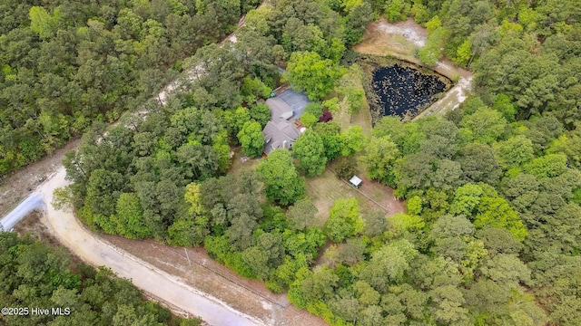 birds eye view of property featuring a wooded view