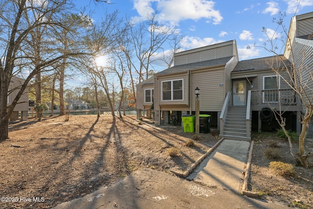 exterior space featuring a shingled roof