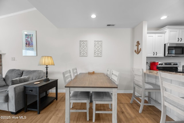 dining area featuring visible vents, recessed lighting, and light wood-type flooring