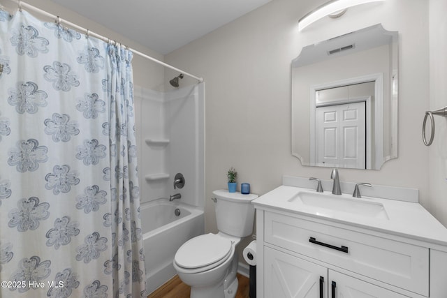 bathroom featuring shower / bath combo with shower curtain, toilet, vanity, and visible vents