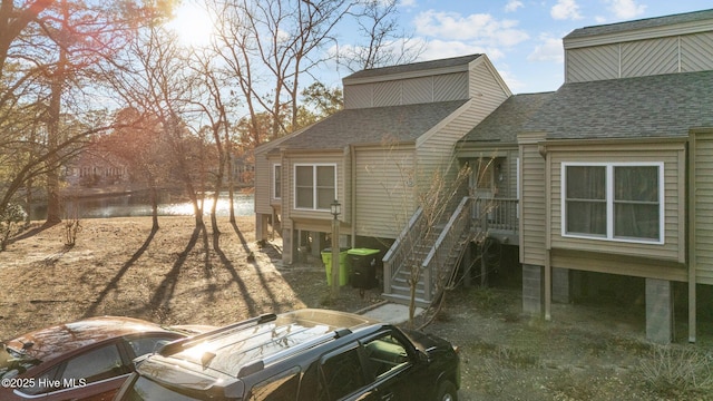 back of house with a shingled roof