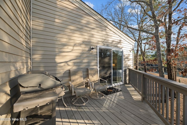 wooden terrace with a grill