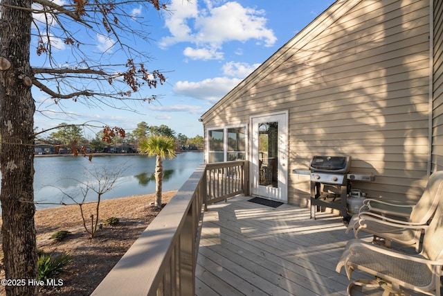 wooden terrace with grilling area and a water view