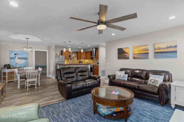151 NE 9th St, Oak Island, NC 28465 - living area featuring recessed lighting, ceiling fan, wood finished floors, baseboards, and a chandelier