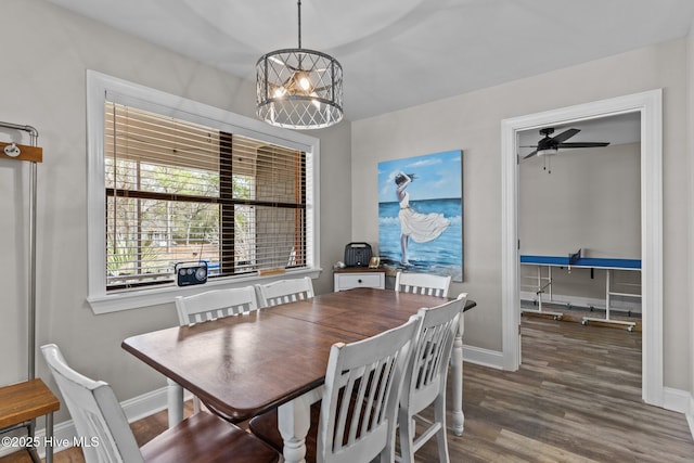 151 NE 9th St, Oak Island, NC 28465 - dining area featuring baseboards, wood finished floors, and a ceiling fan