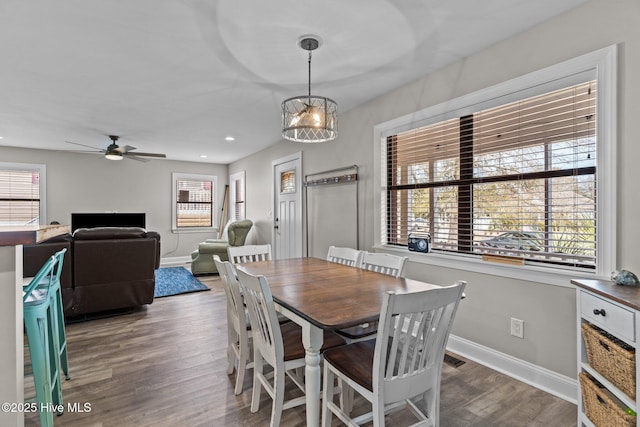 151 NE 9th St, Oak Island, NC 28465 - dining area with ceiling fan, wood finished floors, baseboards, a chandelier, and recessed lighting