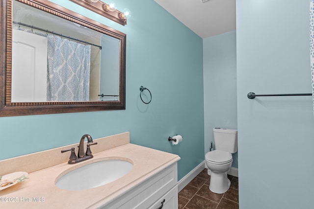 151 NE 9th St, Oak Island, NC 28465 - bathroom with toilet, vanity, and baseboards