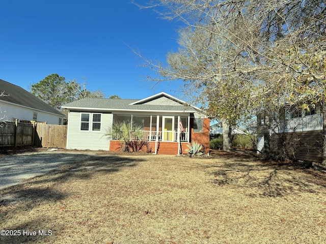 back of house featuring a lawn and fence