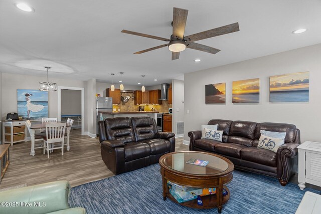 151 NE 9th St, Oak Island, NC 28465 - living area featuring recessed lighting, ceiling fan, wood finished floors, baseboards, and a chandelier