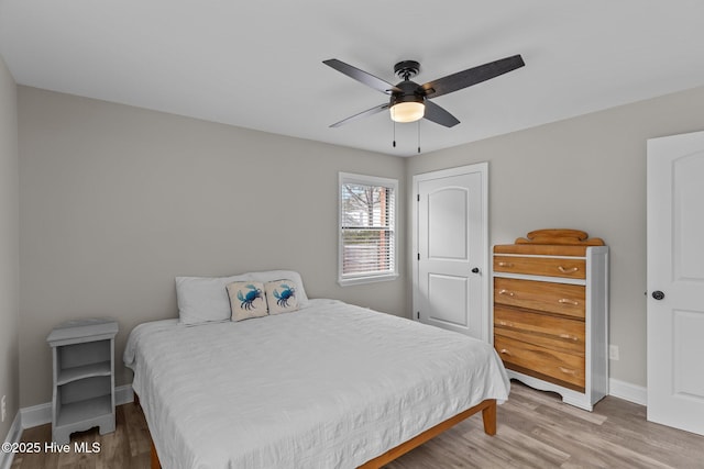 151 NE 9th St, Oak Island, NC 28465 - bedroom with wood finished floors, baseboards, and ceiling fan