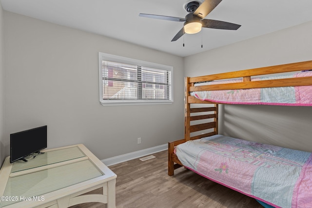151 NE 9th St, Oak Island, NC 28465 - bedroom featuring wood finished floors, baseboards, and ceiling fan