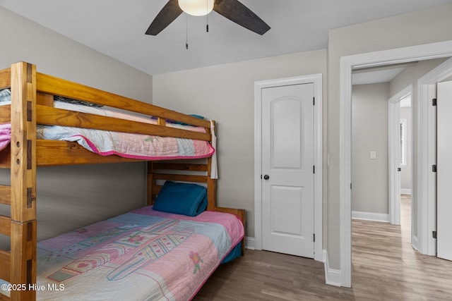 151 NE 9th St, Oak Island, NC 28465 - bedroom featuring wood finished floors, baseboards, and a ceiling fan