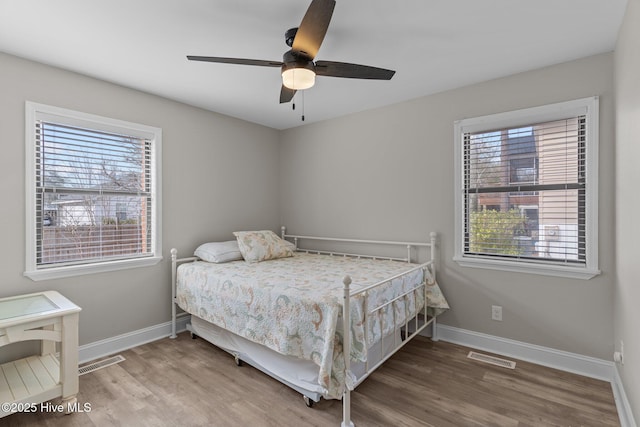 151 NE 9th St, Oak Island, NC 28465 - bedroom featuring baseboards, wood finished floors, and ceiling fan