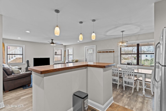 151 NE 9th St, Oak Island, NC 28465 - kitchen featuring wood counters, recessed lighting, light wood-style floors, and a ceiling fan