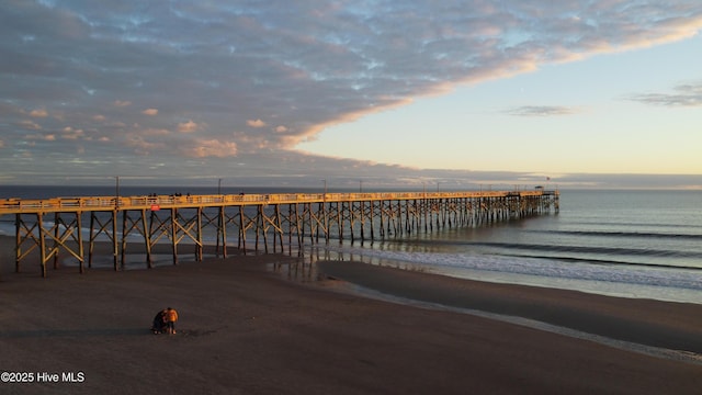 151 NE 9th St, Oak Island, NC 28465 - dock featuring a pier and view of water and beach