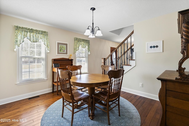 dining space featuring dark wood-style flooring, visible vents, plenty of natural light, and baseboards