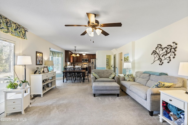 living room with light carpet and ceiling fan