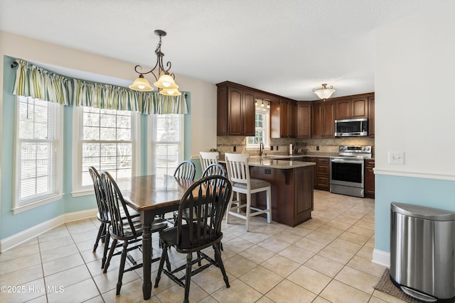 dining area featuring light tile patterned flooring and baseboards