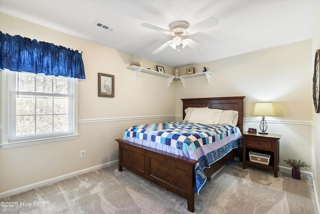 bedroom with carpet floors, visible vents, ceiling fan, and baseboards