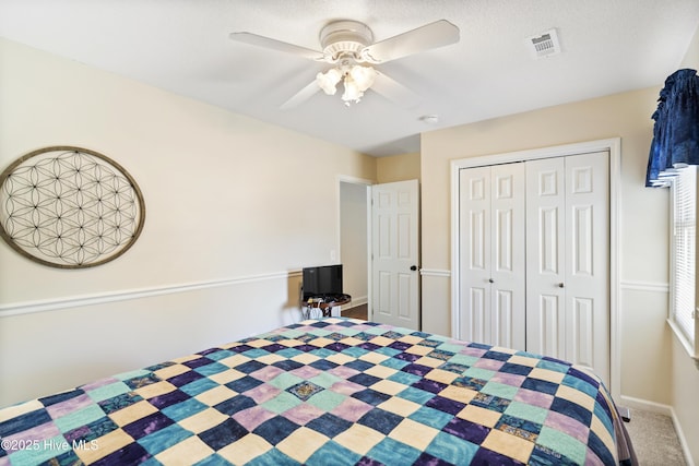 unfurnished bedroom with a closet, visible vents, ceiling fan, and carpet flooring