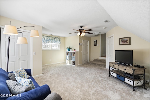 carpeted living room featuring visible vents, ceiling fan, baseboards, and stairs