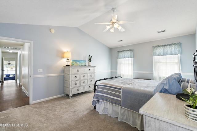 bedroom featuring visible vents, vaulted ceiling, and carpet flooring