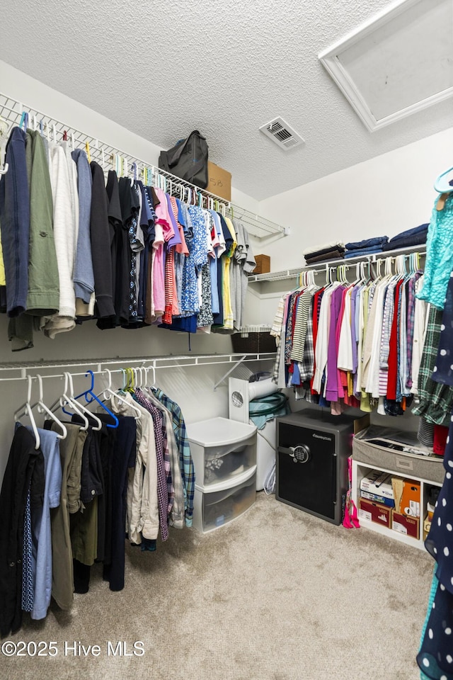 walk in closet featuring visible vents and carpet flooring