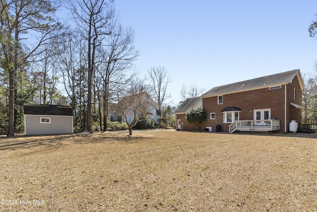 view of yard with a deck and an outbuilding