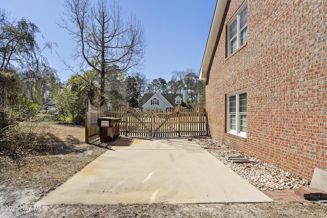 view of patio with a gate and fence