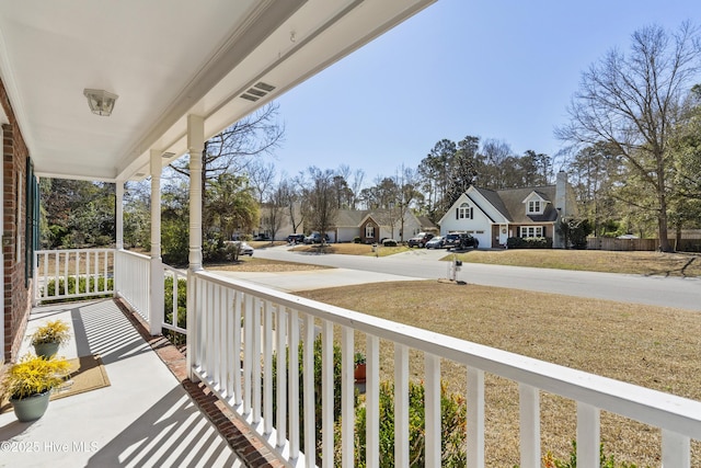 balcony with covered porch and a residential view