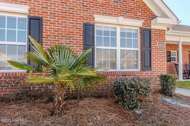 view of side of property featuring brick siding