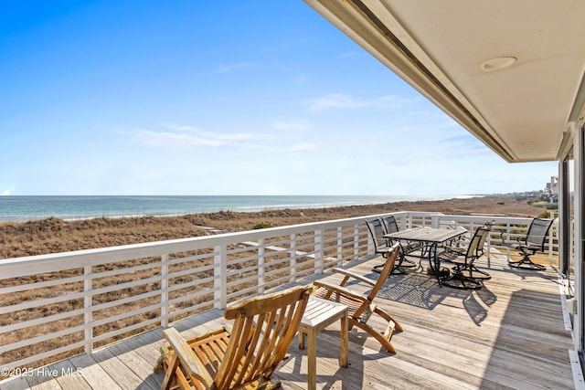 wooden terrace with a water view and a view of the beach