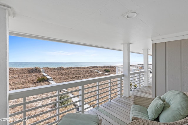 balcony with a beach view and a water view