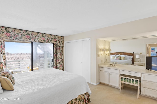 bedroom featuring a closet, light colored carpet, and baseboards