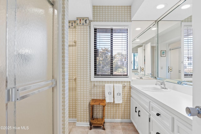 full bathroom featuring wallpapered walls, baseboards, a shower, tile patterned flooring, and vanity