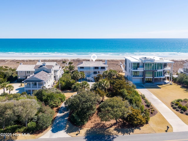 drone / aerial view featuring a water view and a view of the beach