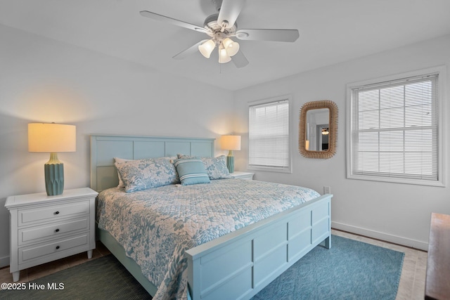 bedroom with ceiling fan and baseboards