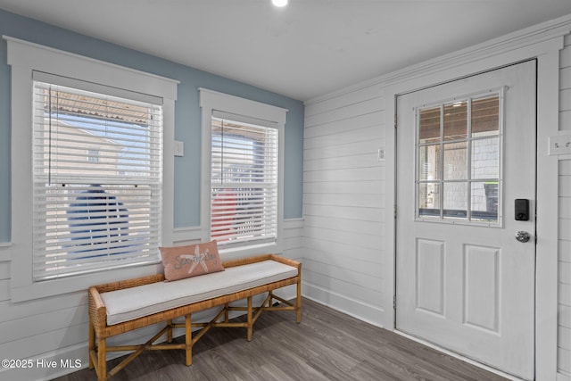 dining area with wood walls and wood finished floors