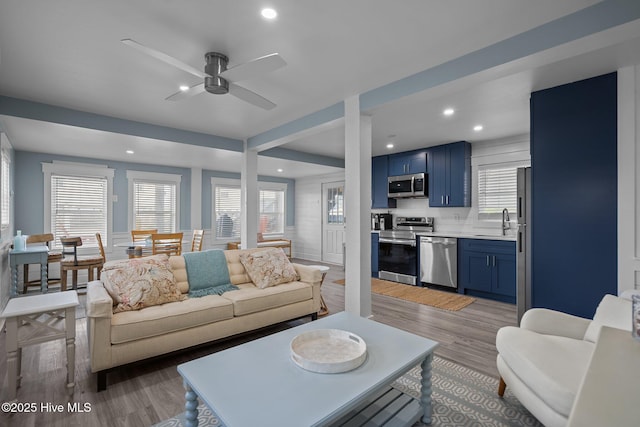 living room featuring recessed lighting, ceiling fan, and light wood finished floors