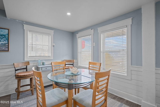 dining space featuring recessed lighting, wainscoting, and wood finished floors