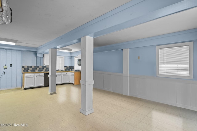 basement with wainscoting and light floors