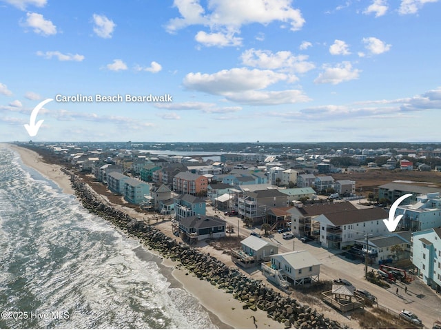 drone / aerial view featuring a water view and a view of the beach