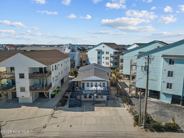 drone / aerial view with a water view and a residential view