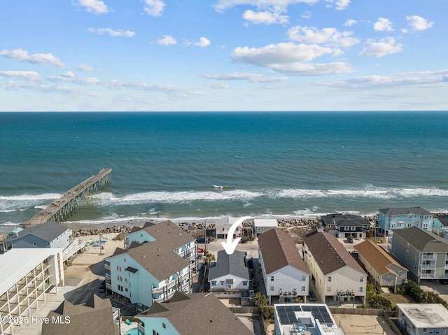 drone / aerial view featuring a residential view, a view of the beach, and a water view