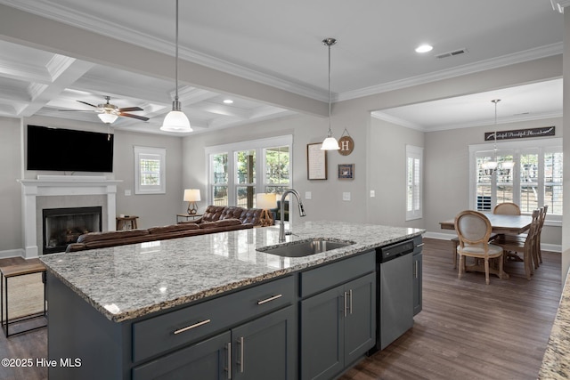 kitchen featuring visible vents, dark wood-type flooring, beam ceiling, stainless steel dishwasher, and a sink