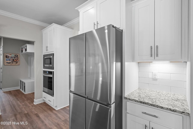 kitchen with dark wood-style floors, crown molding, decorative backsplash, appliances with stainless steel finishes, and white cabinetry