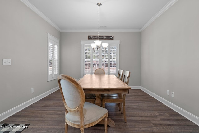 dining room featuring dark wood-type flooring, crown molding, a notable chandelier, and baseboards