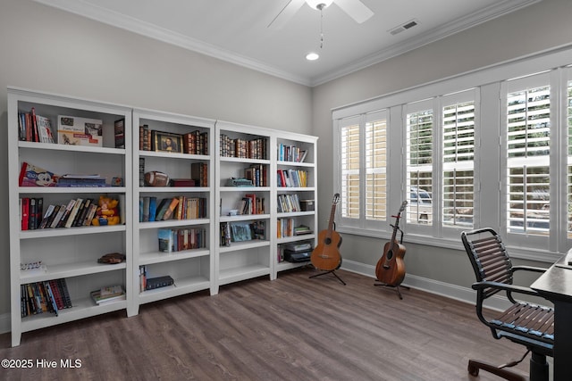 office with wood finished floors, a ceiling fan, baseboards, visible vents, and crown molding